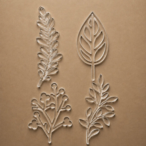 The four botanical stencil designs in the set: fern, leaf, berry branch and sprig