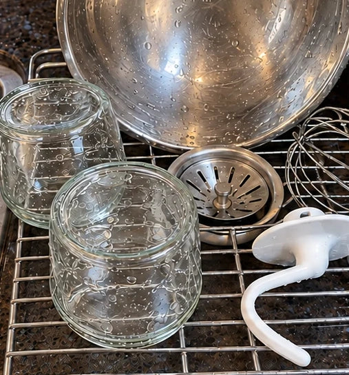 Clean jars, mixing bowl, whisk and dough hook drying on a rack